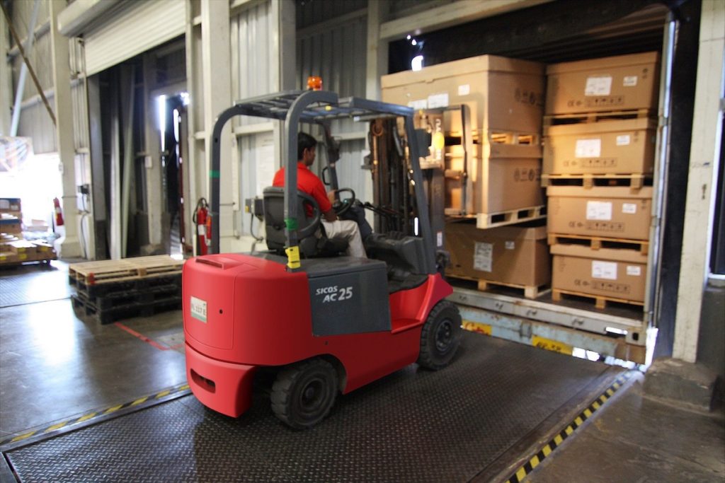 forklift unloading freight from dry van trailer